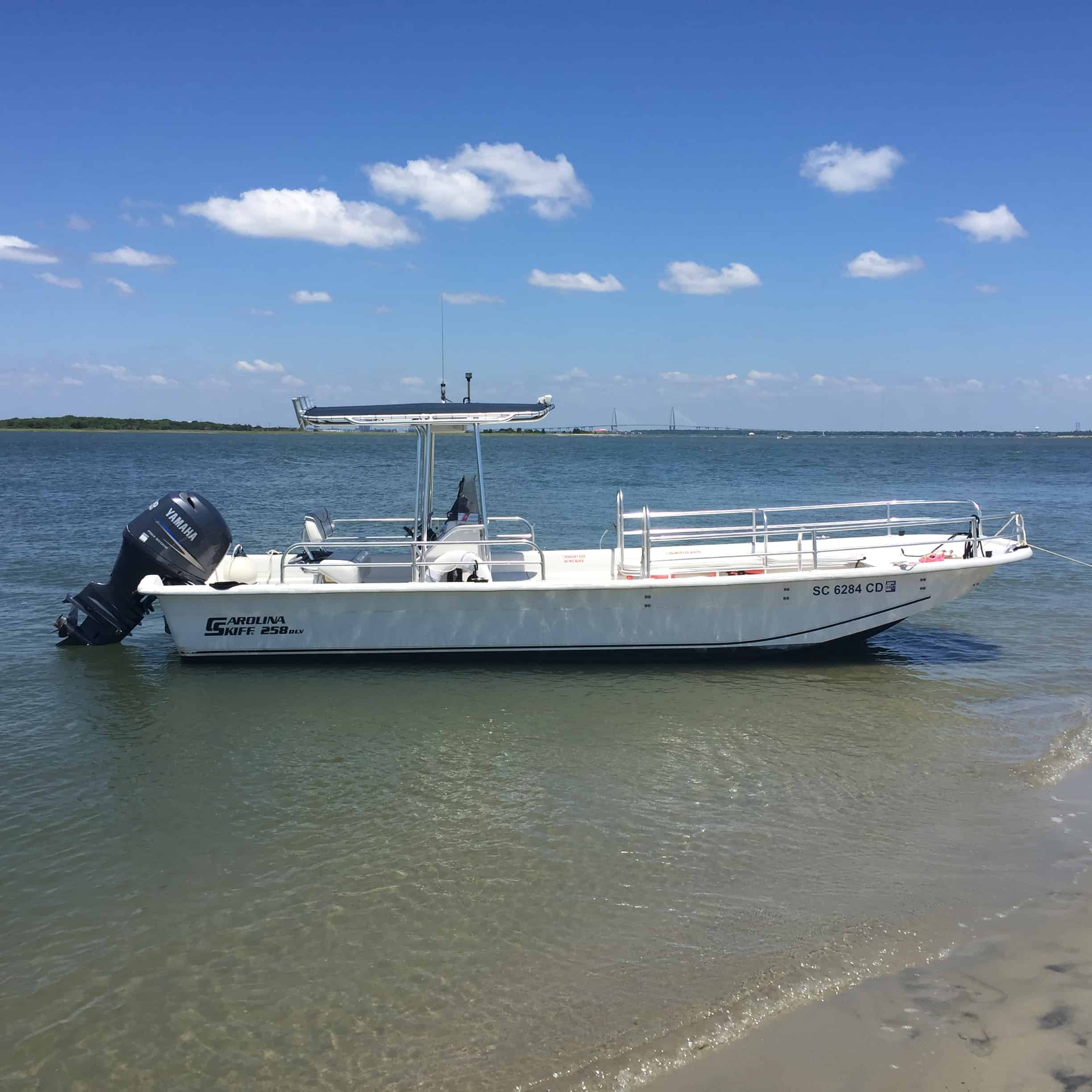Skiff boat docked on the beach. Party boat rental Charleston, SC
