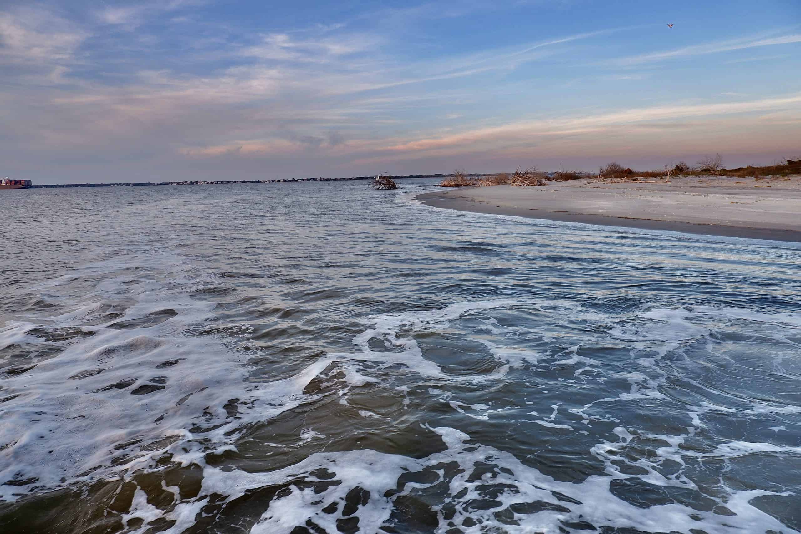 Beautiful picture of the water and the beach as the sun sets. Boat charter Charleston, SC